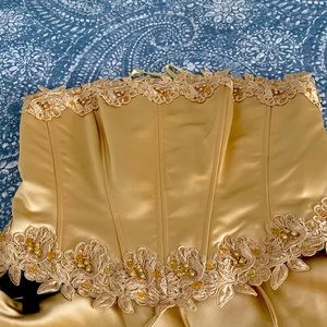 This is a two piece formal ensemble! It is gold and embroidered with gems.